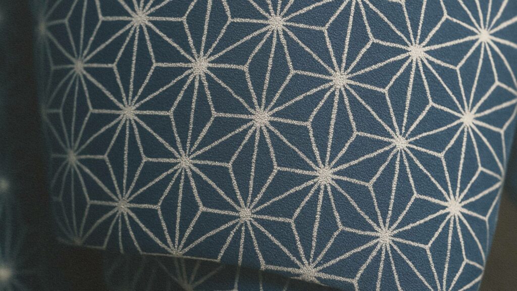 Motif Asanoha en gros plan sur un tissu japonais traditionnel – lignes géométriques blanches formant des étoiles à six pointes, symbole de croissance et de protection.